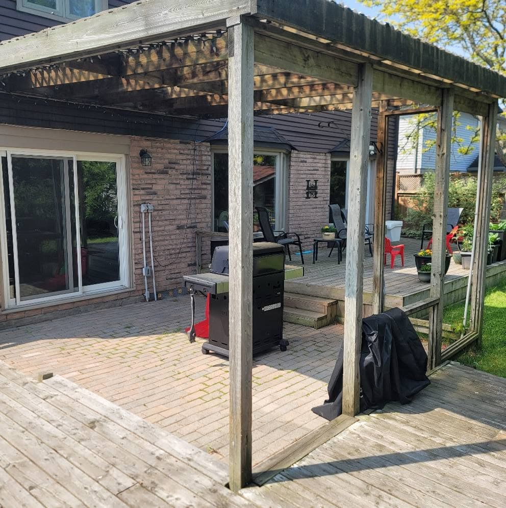 Backyard deck with a pergola and patio area