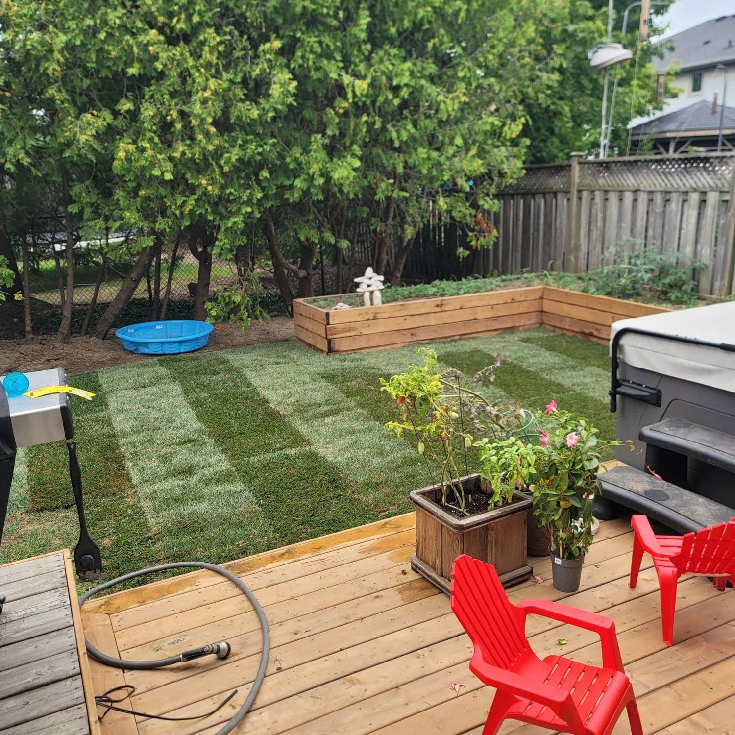 Finished backyard deck with a freshly cut, striped lawn
