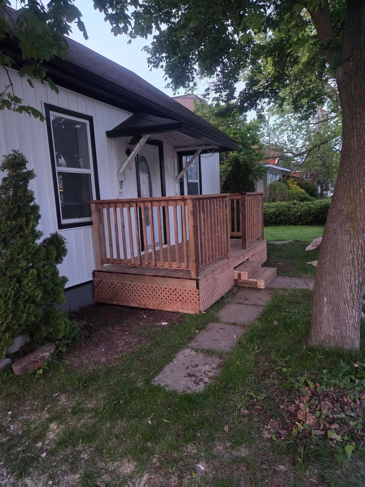 Freshly built cedar porch and railing on a Hamilton home exterior