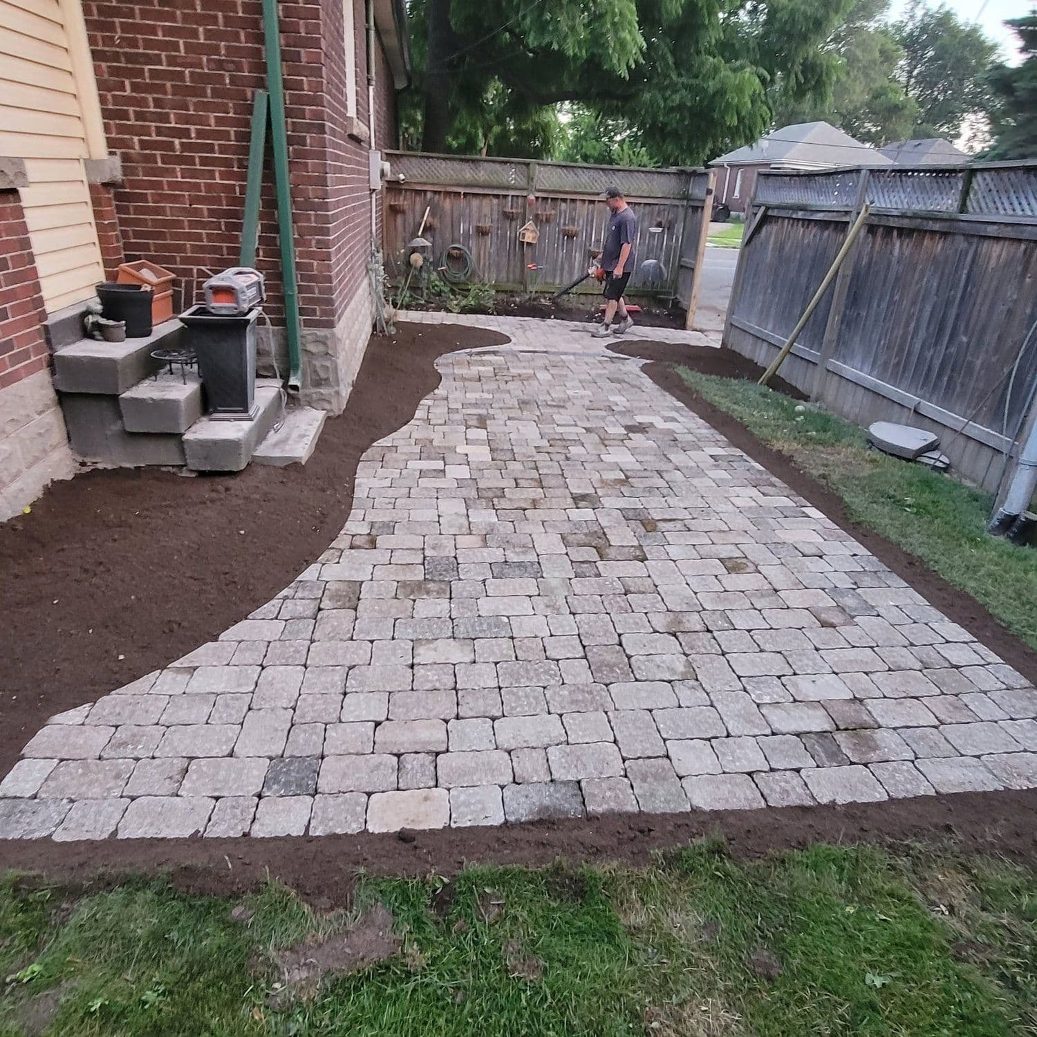 Interlock paver walkway winding along the side of a Hamilton home
