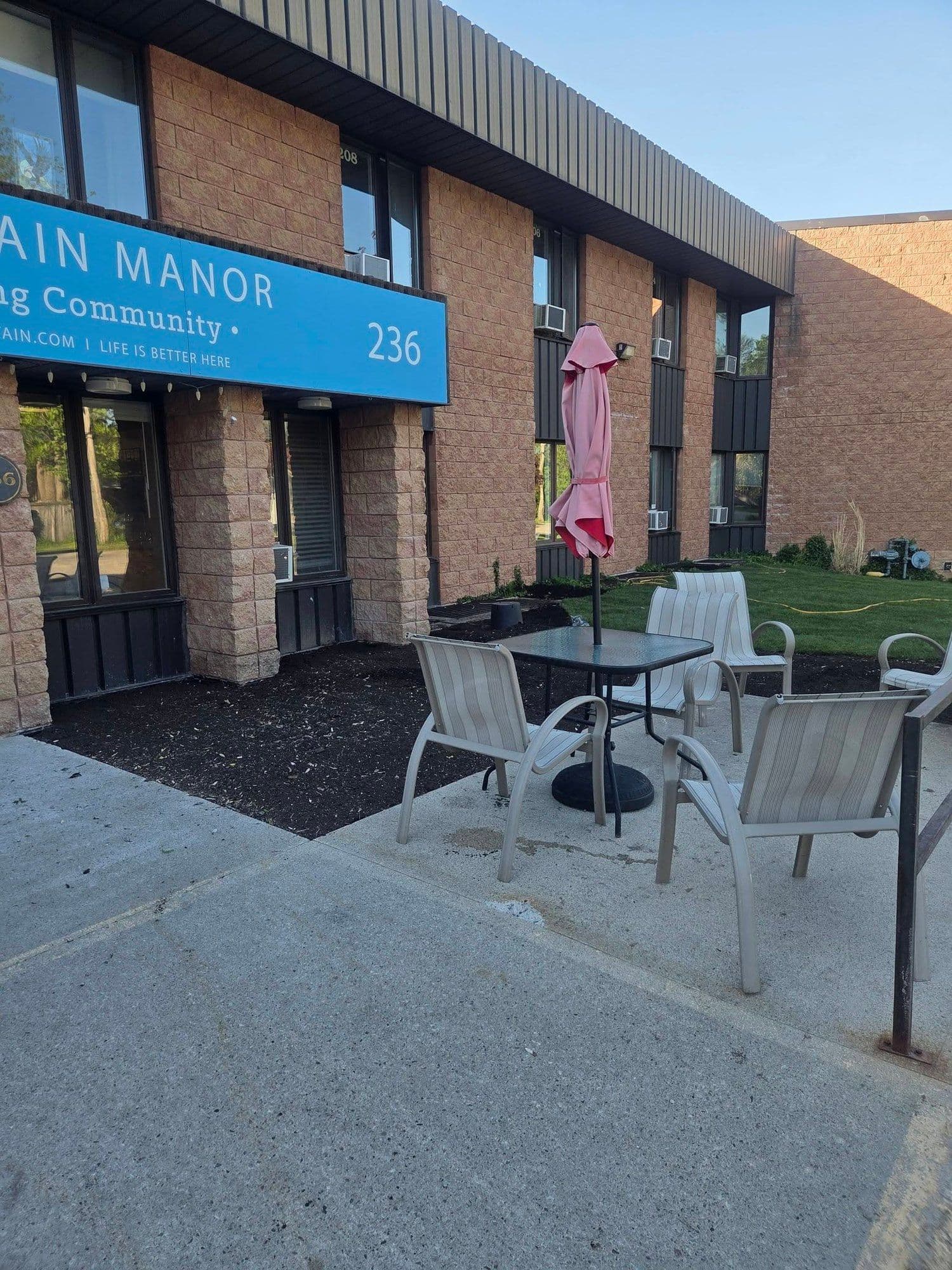 Interlock paver patio installed outside a multi-unit building